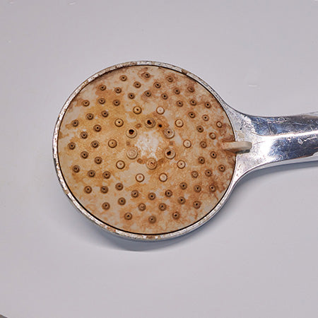 an image showcasing the lime scales on a bathroom tap and some bathroom appliances