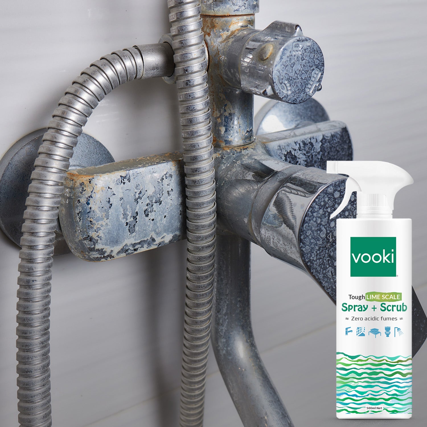 An image of vooki limescale spray+scrub bottle and on the background a shower hose attached 