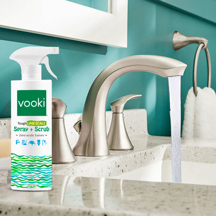 A counter displaying a bottle of vooki cleaning spray alongside a sink, ideal for cleaning purposes.